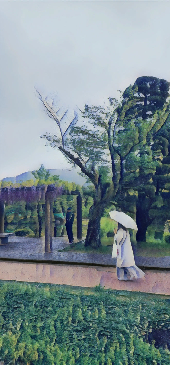 Person with white umbrella walking along a path in a Japanese garden near a pergola; rainy day.